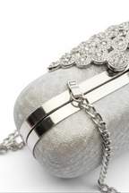 A close-up of the Pearl Chain Handbag featuring a metallic chain shoulder strap and decorative rhinestones on top, set against a white background.