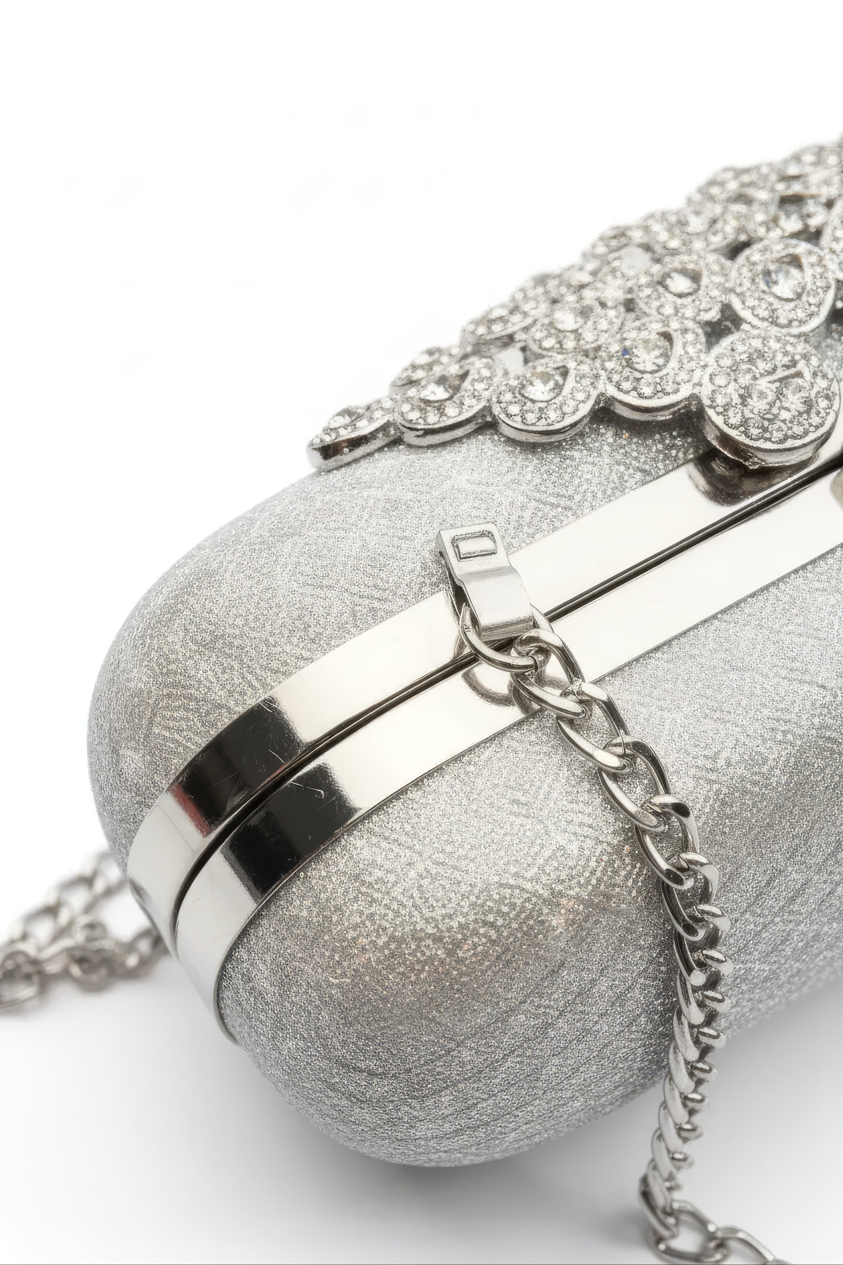 A close-up of the Pearl Chain Handbag featuring a metallic chain shoulder strap and decorative rhinestones on top, set against a white background.