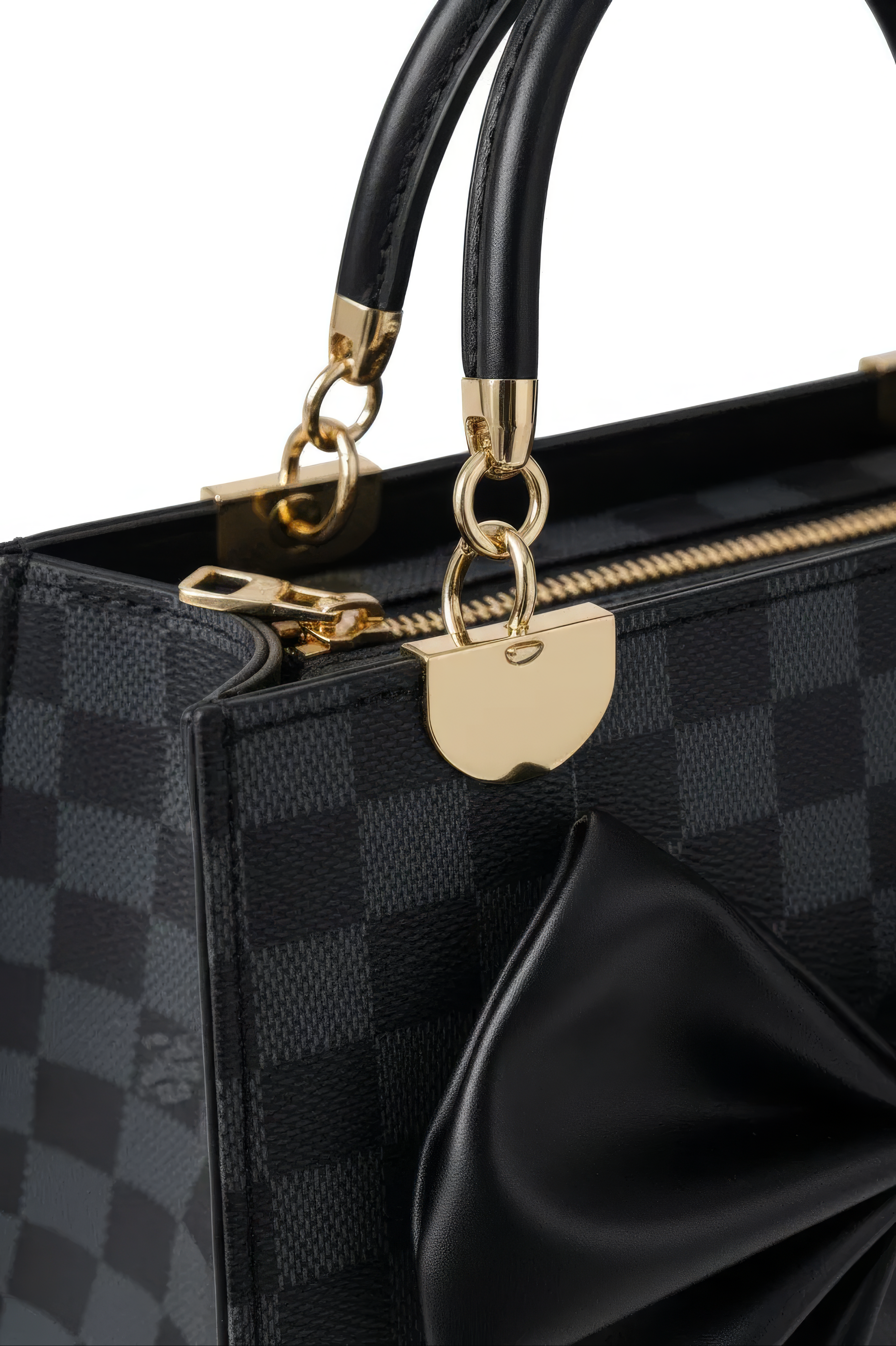 Close-up of the Nocturne Bow Handbag: a luxury black leather bag with a black checkered pattern, gold hardware, black handles, a large side bow accent, and a detachable shoulder strap for versatile carrying.
